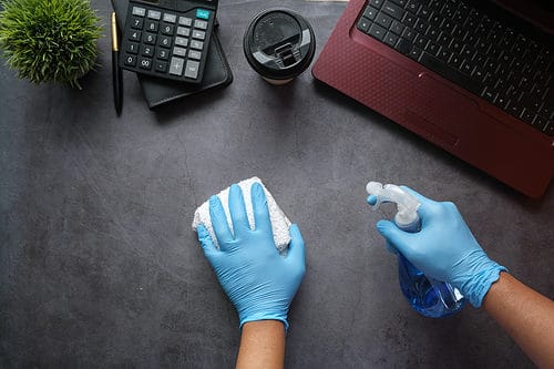 cleaning with spray and cloth, a desk and workstation area