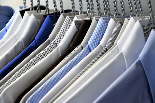 Freshly pressed work shirts hung up on hangers